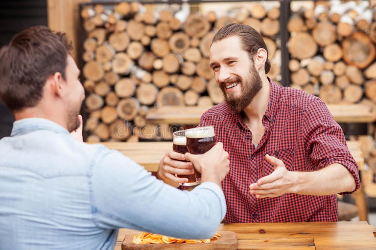 cheerful-young-men-resting-pub-attractive-two-guys-drinking-beer-bar-sitting-table-opposite-each-other-59975750.jpg