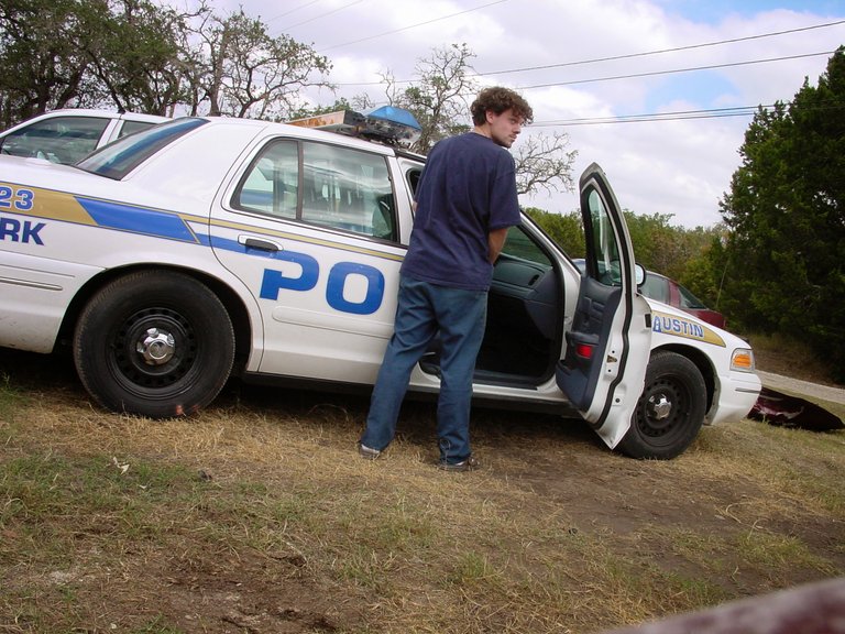 ricky pissing in cop car.jpg