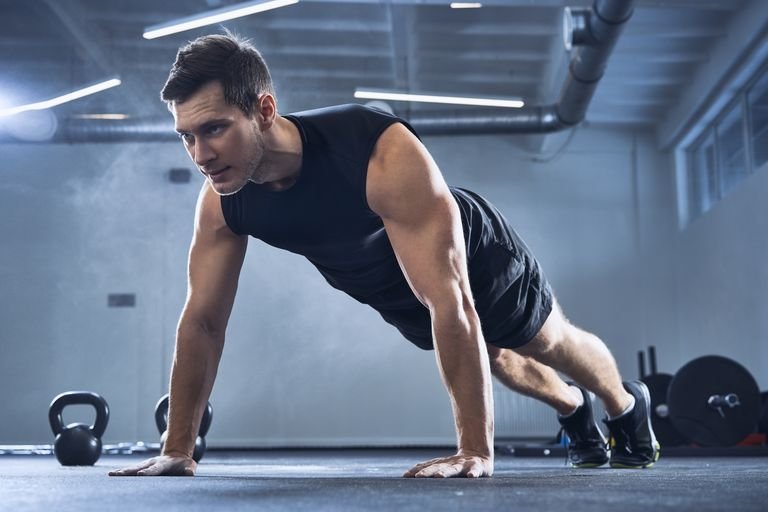 athletic-man-doing-pushups-exercise-at-gym-royalty-free-image-982408932-1542407555.jpg