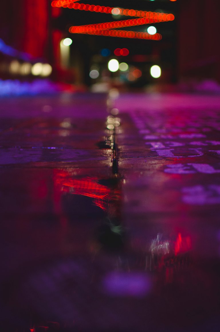 The wet alley way under the glowing lights.JPG