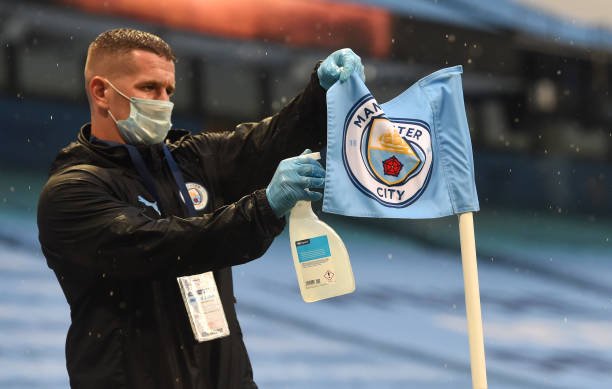 manchester-city-member-of-staff-disinfects-a-corner-flag-prior-to-the-picture-id1250312541.jpg