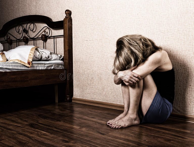 sad-woman-sitting-alone-empty-room-next-to-bed-domestic-violence-73832260.jpg