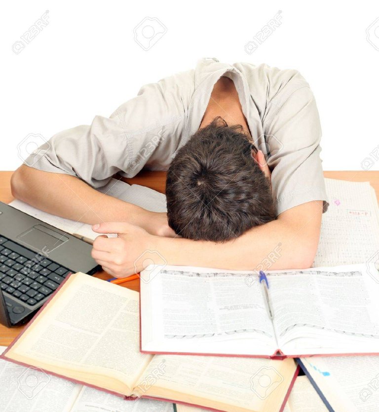 16908020-tired-student-sleeping-on-the-school-desk-isolated-on-the-white-background.jpg