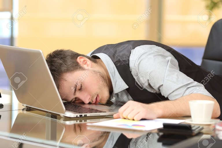 64541272-tired-overworked-businessman-sleeping-over-a-laptop-in-a-desk-at-job-in-his-office.jpg