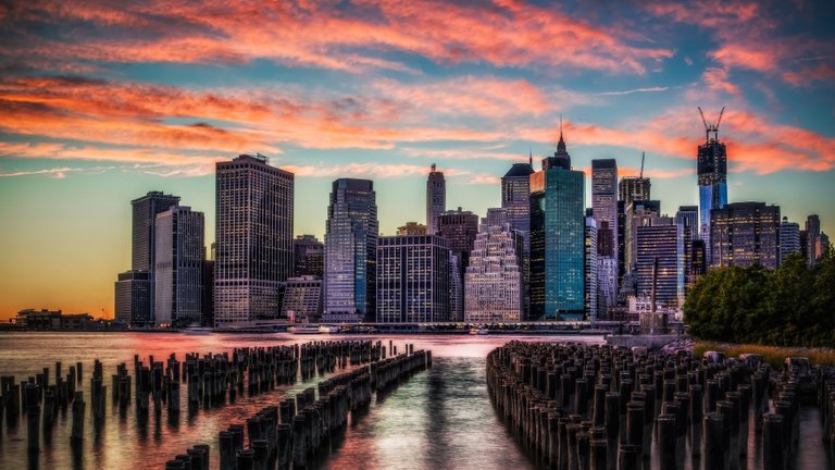 architectureimg.com-skyscrapers-wooden-pillars-new-york-city-bay-stretched-sunset-clouds-skyscrapers-fullscreen-wallpaper.jpg