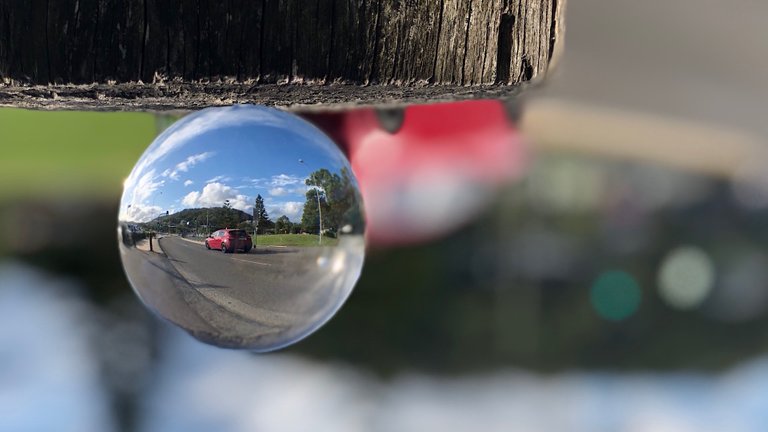 A red car through a lensball