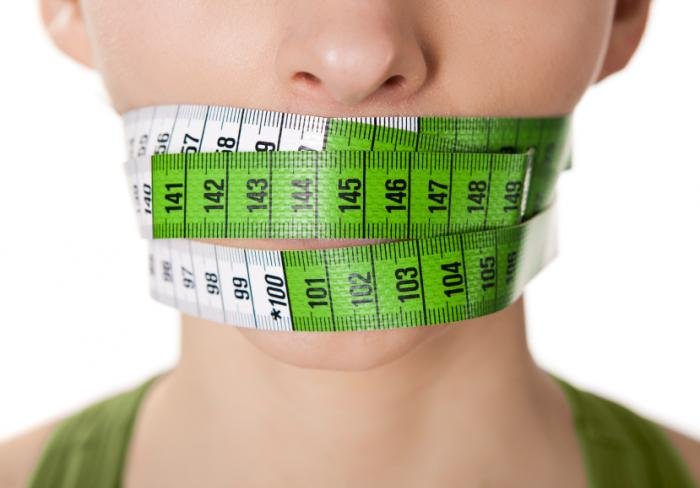 woman-with-tape-measure-around-mouth.jpg