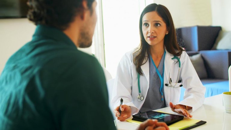 Doctor speaking to male patient