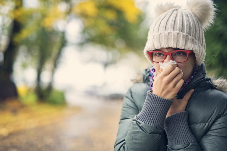 A woman with a cold in autumn