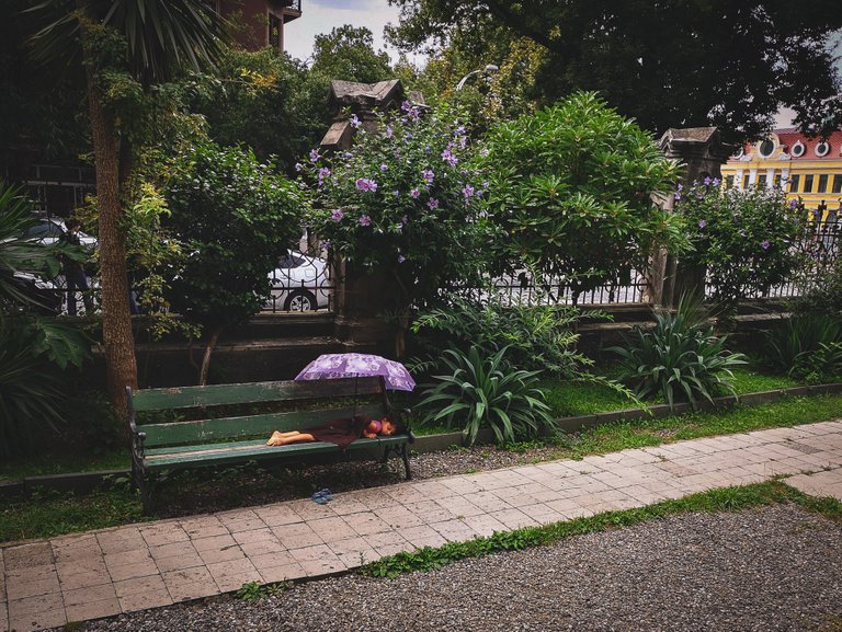 Girl sleeping on a bench near Batumi Cathedral, Georgia