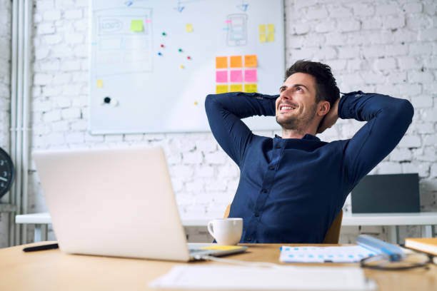 Smiling handsome businessman relaxing and enjoying coffee while taking break from work in office - Credit to https://www.lyncconf.com/