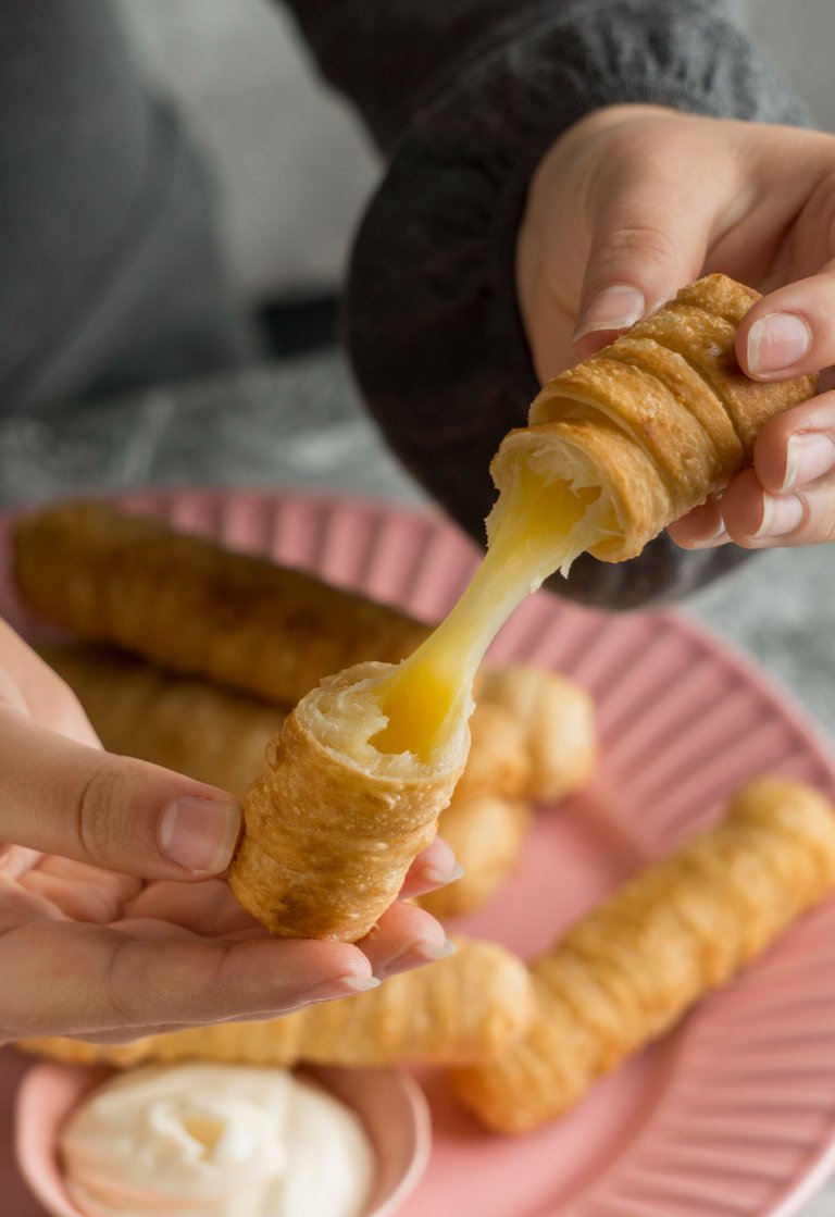 woman-enjoying-some-traditional-tequenos.jpg