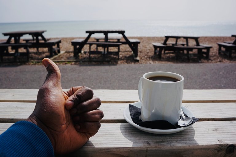 Sitting outside a beach cafe in Hove with my hot cup of black coffee