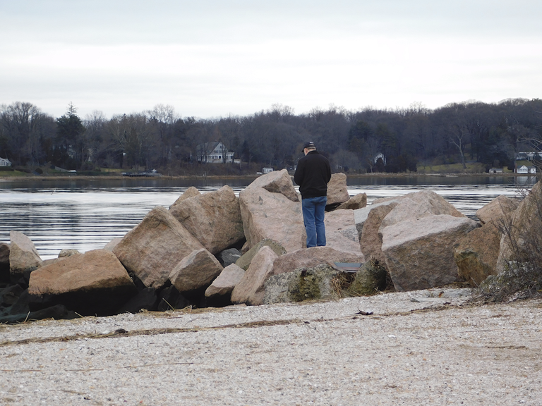 man on rocks oyster bay2.png