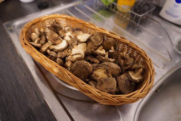 A basket full of fresh shiitake mushrooms