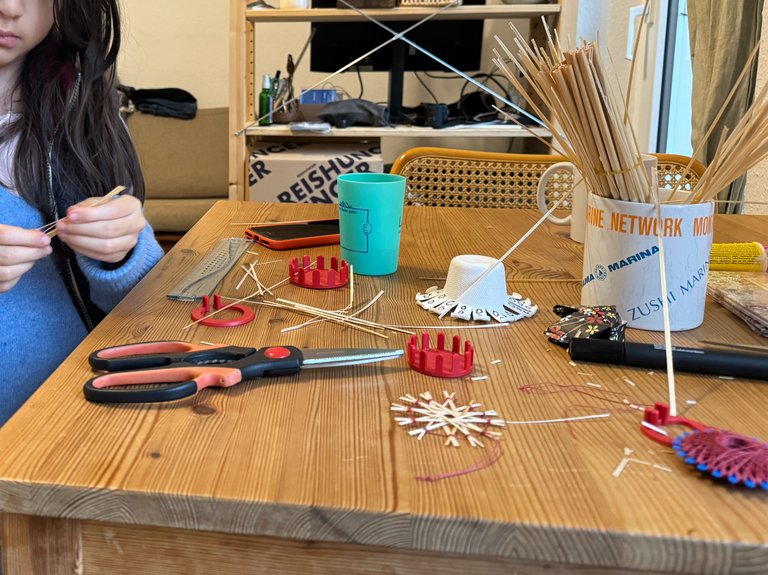 Our dining table turned into a straw star factory