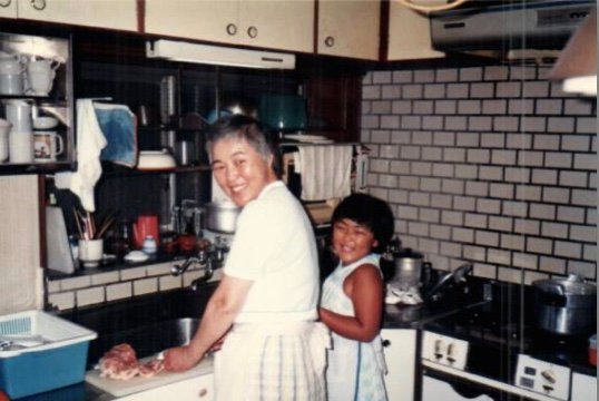 A treasured memory: me with my grandmother in the kitchen at my grandparents' house