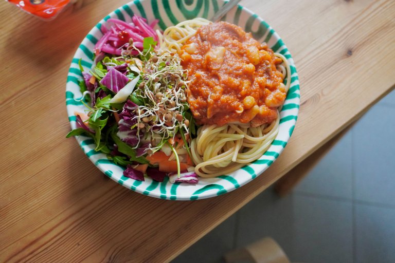 Pasta with tomato sauce and beans, served with a fresh salad