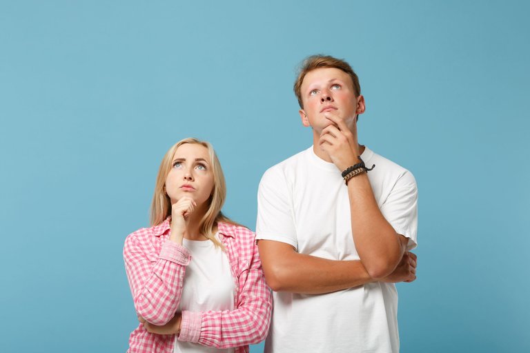 young-pensive-couple-two-friends-man-and-woman-in-white-pink-blank-empty-t-shirts-posing.jpg