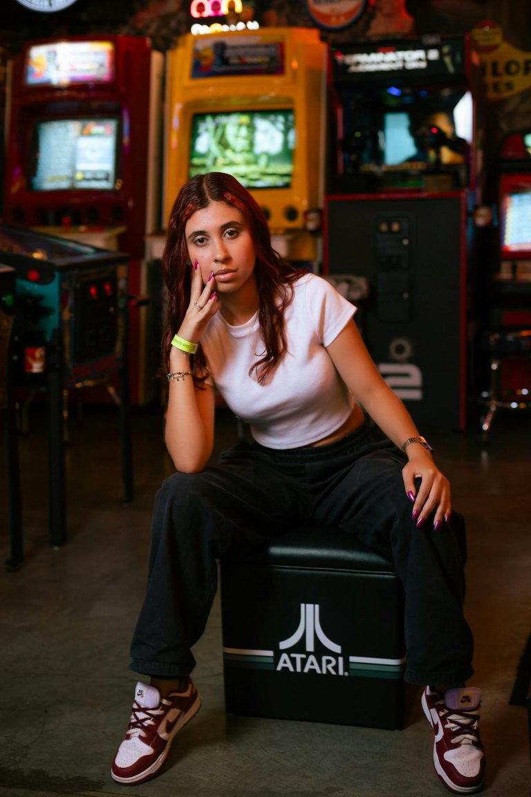 free-photo-of-woman-sitting-and-posing-at-an-arcade.jpeg