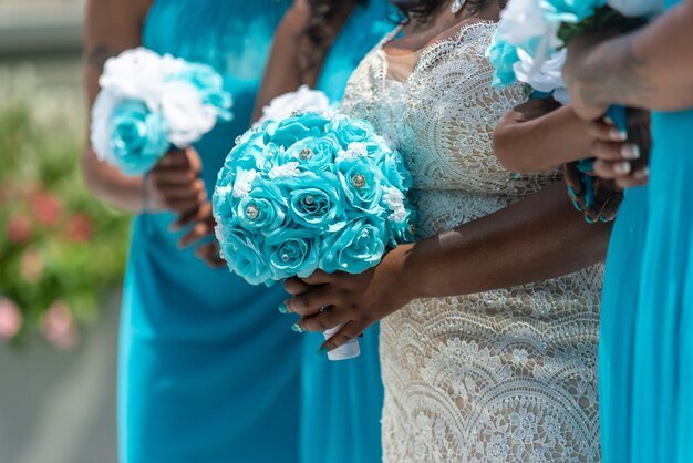 closeup-shot-bride-her-bridesmaids-standing-holding-bouquets-no-faces-captured_181624-24551.jpg