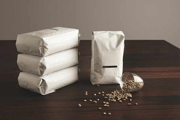 big-hermetic-package-with-blank-label-presented-near-other-four-lying-pouches-filled-with-roasted-coffee_346278-891.jpg