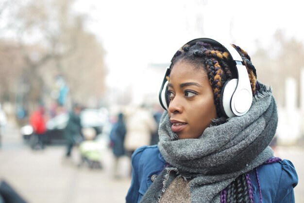 young-woman-walks-down-street-listening-music_641386-375.jpg