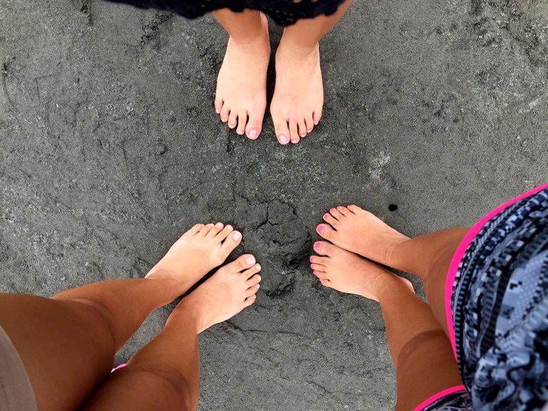 16 Gray volcanic sand and tanned feet.png