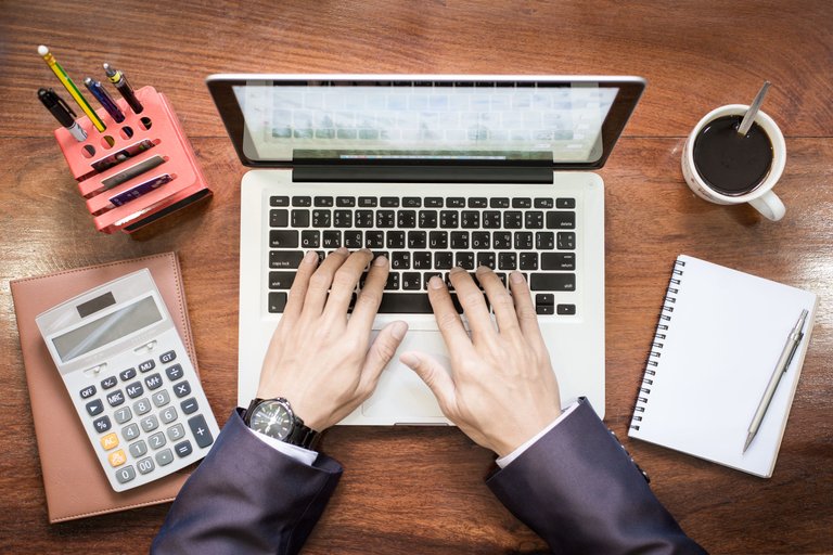 top-view-business-man-hands-working-laptop-tablet-pc-wooden-desk.jpg