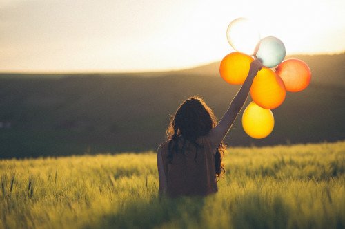 Person with baloons by Catalin pop from Unsplash