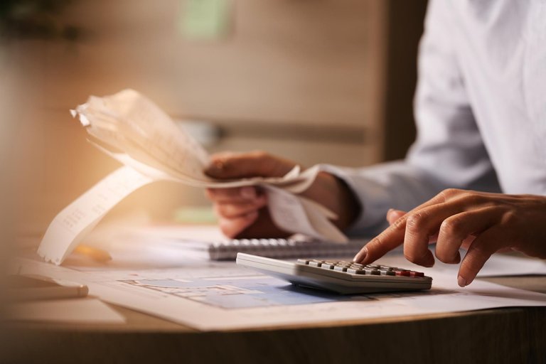 closeup-economist-using-calculator-while-going-through-bills-taxes-office.jpg