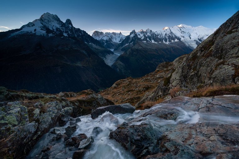 mount-mont-blanc-surrounded-by-rocks-river-with-long-exposure-chamonix-france.jpg