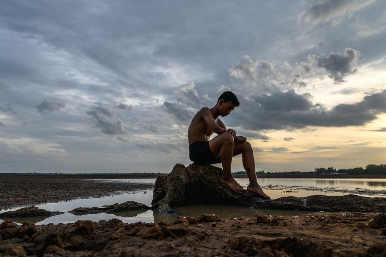 man-sat-bent-his-knees-base-tree-where-floor-was-dry-hands-placed-head.jpg