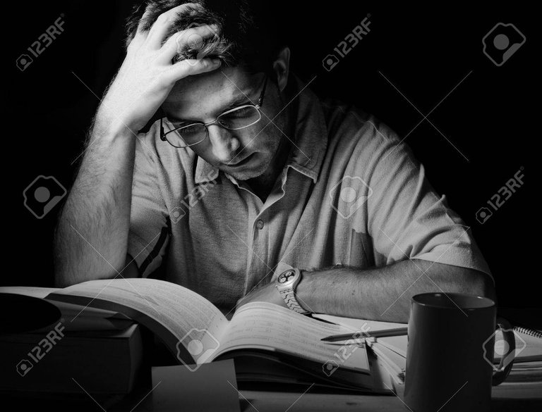 21621279-black-and-white-young-man-studying-at-night.jpg