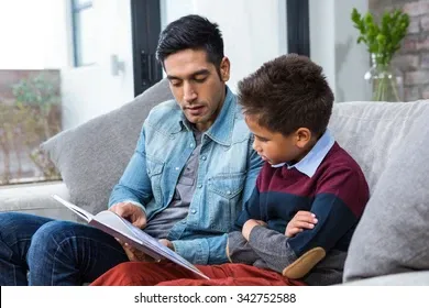 happy-father-reading-book-his-260nw-342752588 (1).webp