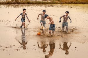 free-photo-of-children-playing-football-in-a-muddy-field.jpeg