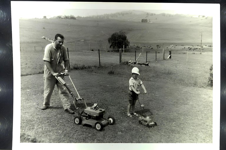 YOUNG DAD AND STEVE MOWING THE BACKYARD.JPG
