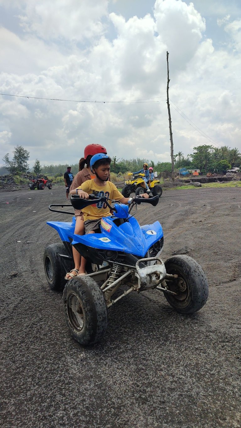 My first born with his blue helmet and ATV.