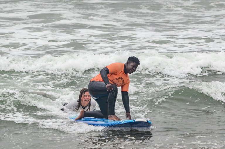 kid trying to stand up in a surf board.jpg