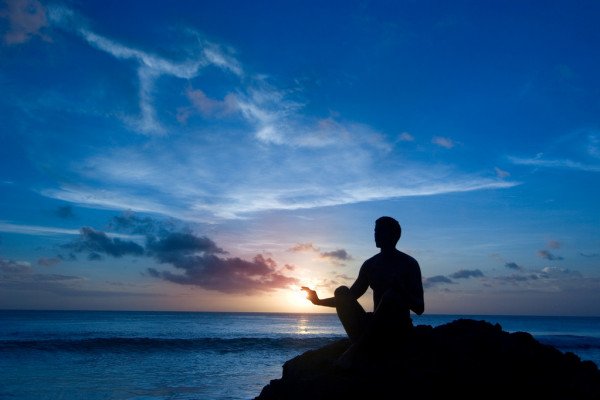 depositphotos_6431452-stock-photo-keeping-sun-young-man-meditating.jpg