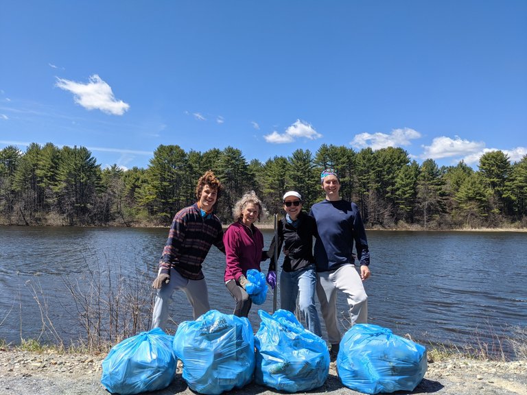 The treasures of our cleanup efforts pictured in front of the Connecticut River along River Road in Lyme, NH. The town comes around and picks up the blue trash bags.