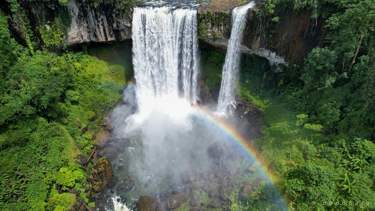 The steam from the waterfall combined with the rays of the sun created a beautiful rainbow.