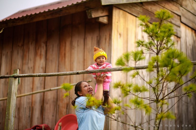 This child is very happy with the exercise with his or her mother.