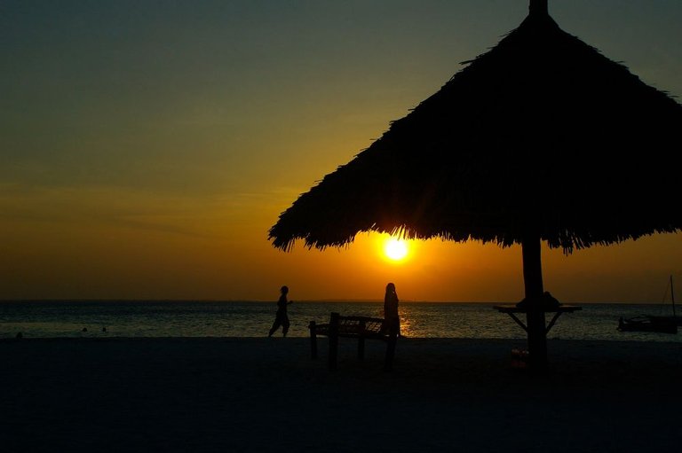 A young couple who are enjoying the romantic atmosphere of Kendwa Beach sunset