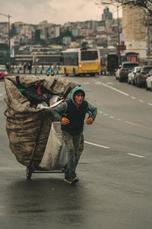 free-photo-of-a-man-carrying-a-large-cart-on-the-street.jpeg