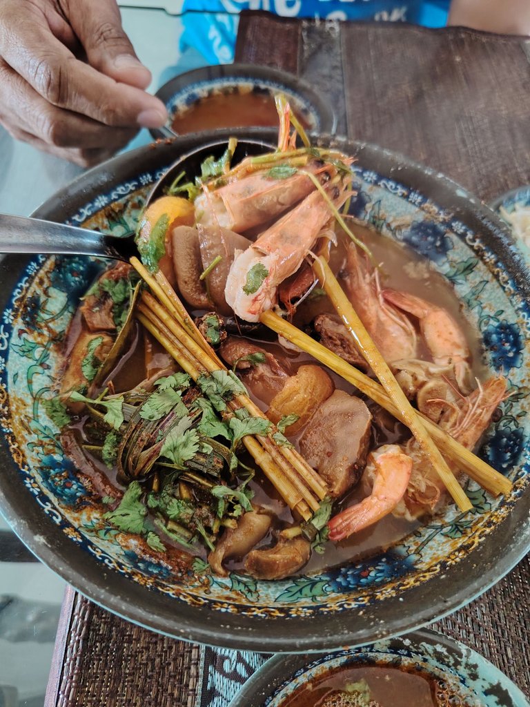 Tom Yum soup—medium spicy with prawns, lemongrass, galangal, kaffir lime leaves, and coriander.