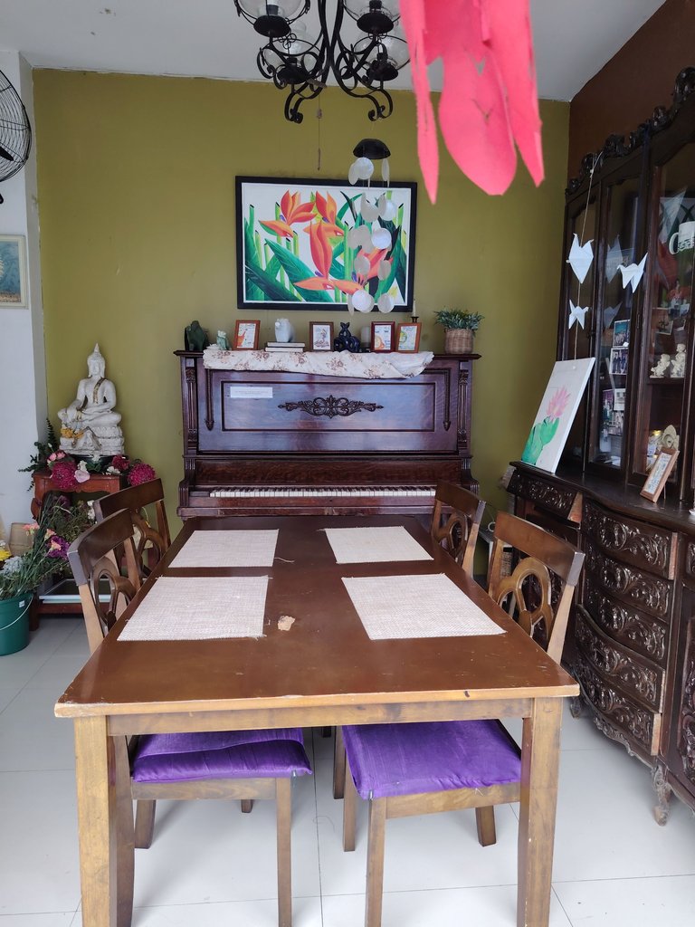 Simple dining setup with an old piano