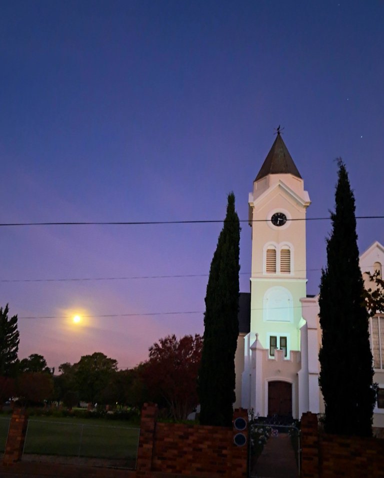 The rising moon over the church