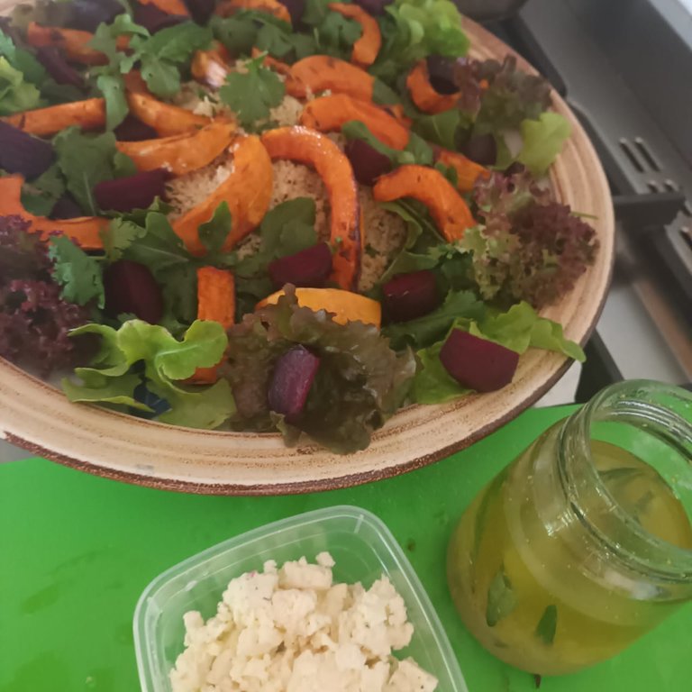 Roasted butternut and beetroot on a bed of couscous and salad leaves