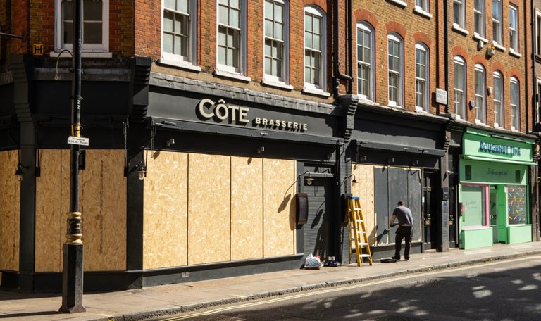 Restaurants being boarded up in Soho, London - Photograph by Antonio Olmos via The Observer
